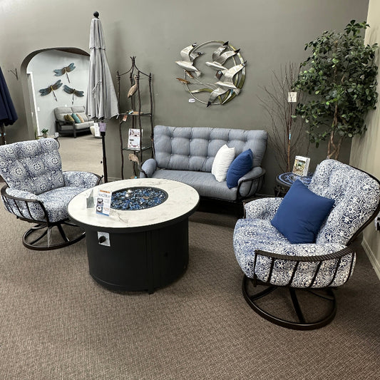 Modern living room with gray sofa, patterned chairs, and decorative items.