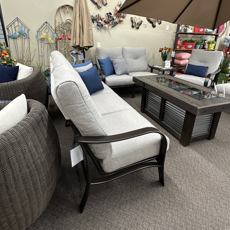 Living room with gray sofa, armchair, and coffee table with decorative items.