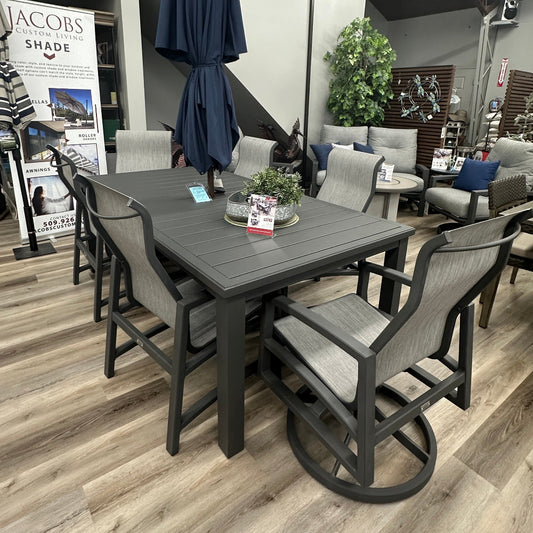 Outdoor furniture set with a table and chairs on a wooden floor, featuring Jacobs Shade products.