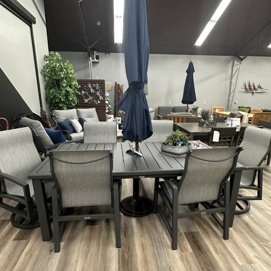 Outdoor furniture set with tables and chairs in a showroom setting.
