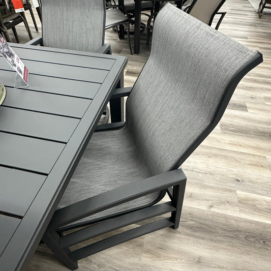 Gray outdoor furniture set on a wooden floor with other furniture in the background.