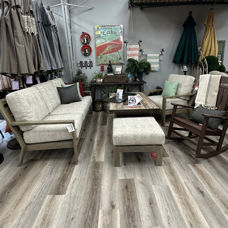 Outdoor furniture set on a wooden floor in a store setting