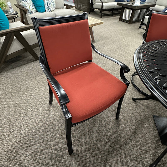 Red chair in a showroom with other furniture in the background