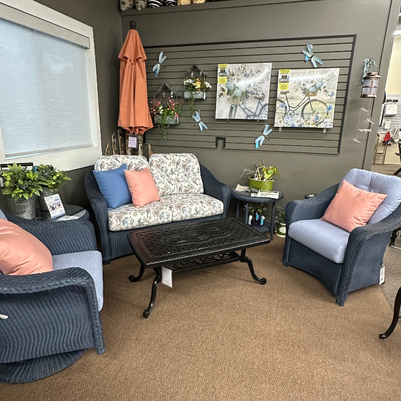 Living room with gray sofa, armchair, and coffee table with decorative items.