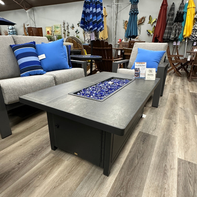 Outdoor furniture set with a table and chairs on a wooden floor, surrounded by patio umbrellas.