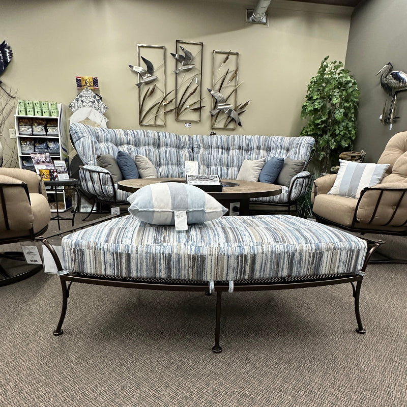 Living room with a sofa, ottoman, and decorative elements.