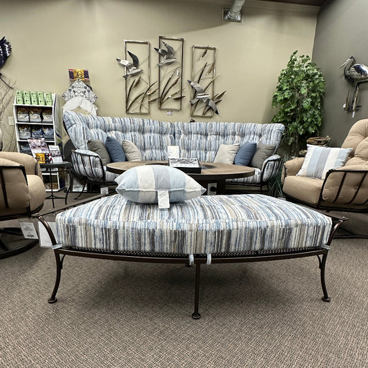 Living room with a sofa, ottoman, and decorative elements.