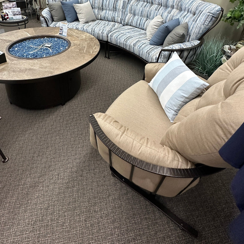 Living room with a curved sectional sofa, coffee table, and decorative elements.