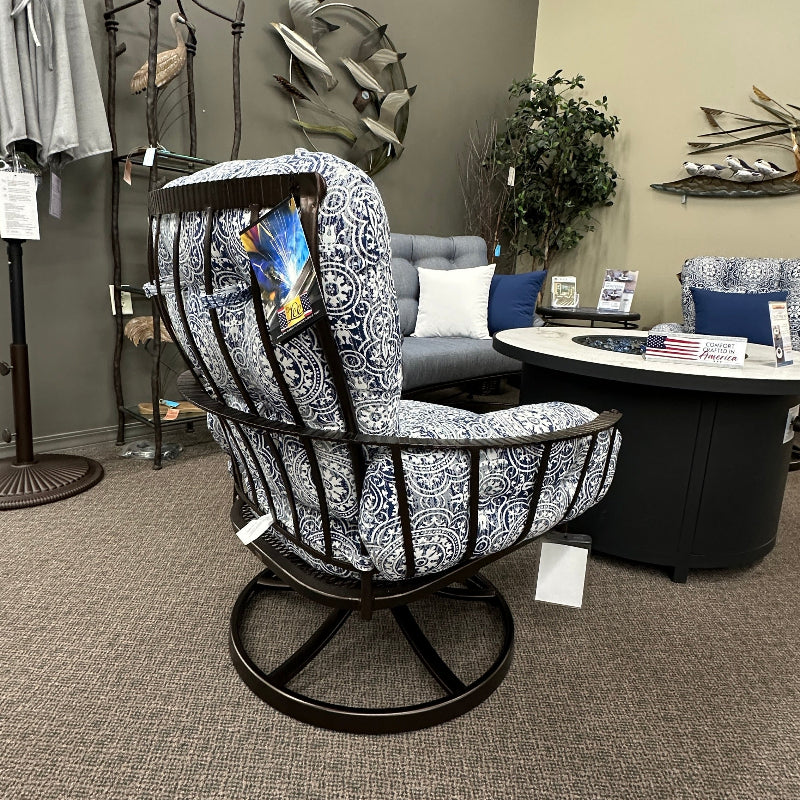 Decorative chair in a room with a table and various items on a gray carpet.
