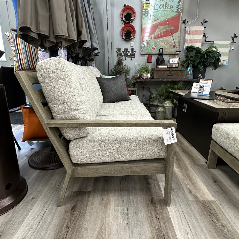 Gray armchair with cushions in a showroom setting