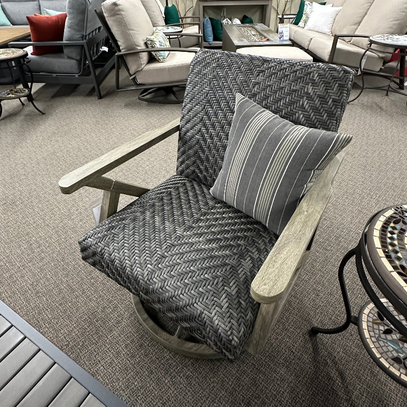 Outdoor furniture set including chairs, tables, and umbrellas in a showroom setting.