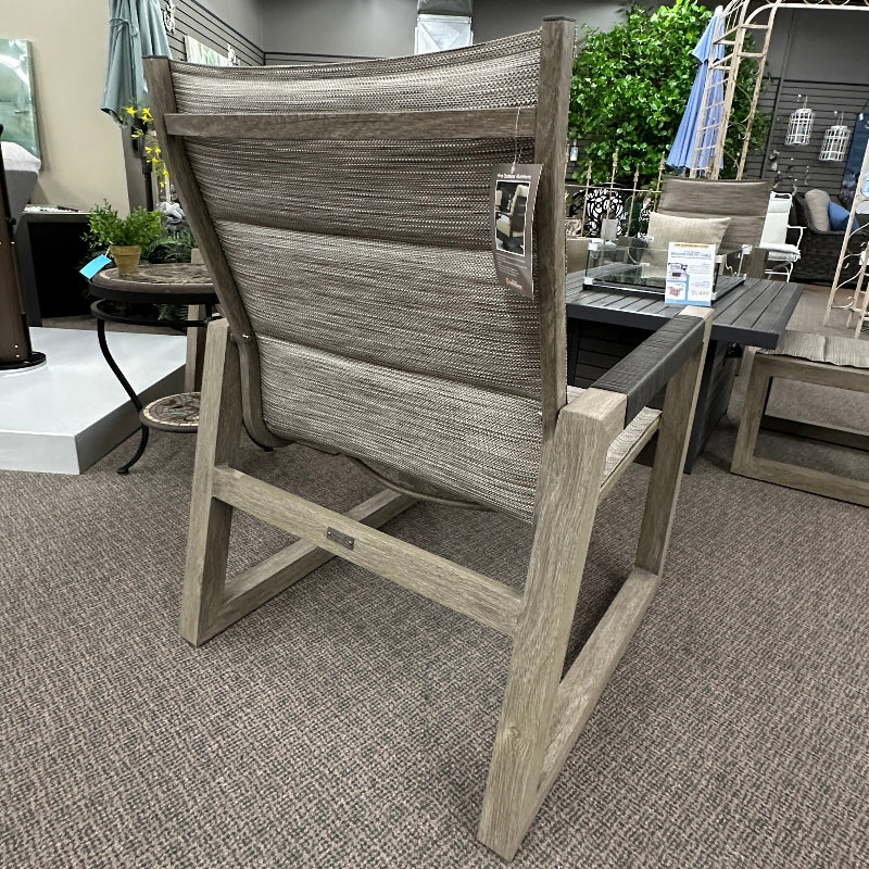 Gray outdoor chair with umbrella on a showroom floor