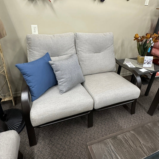 Gray sofa with cushions in a room setting with decorative elements on the wall.