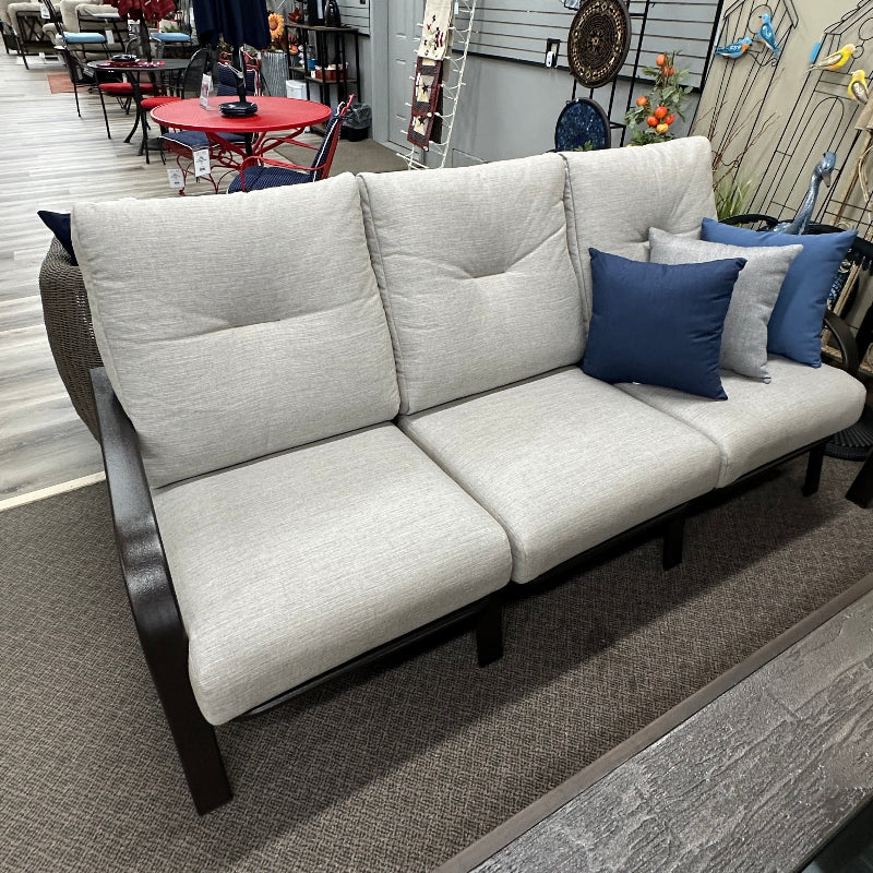 White sofa with blue pillows in a store setting