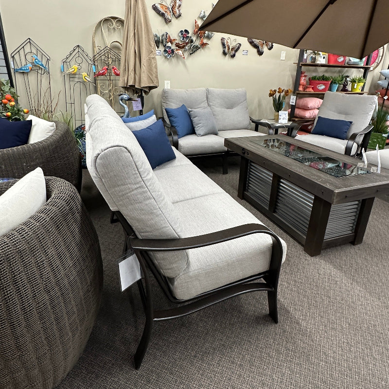 Living room with gray sofa, armchair, and coffee table with decorative items.