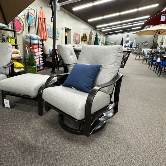 Chair with a blue pillow in an indoor setting with various furniture and decor items.