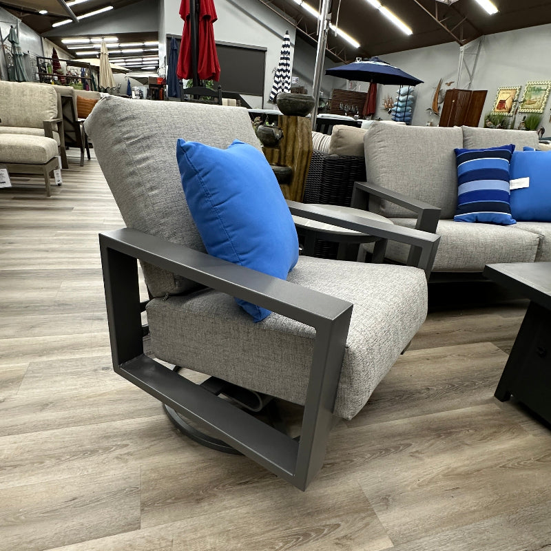 Gray sofa with blue pillows in a showroom setting