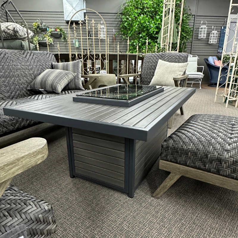 Outdoor furniture set with a table and chairs in an indoor setting