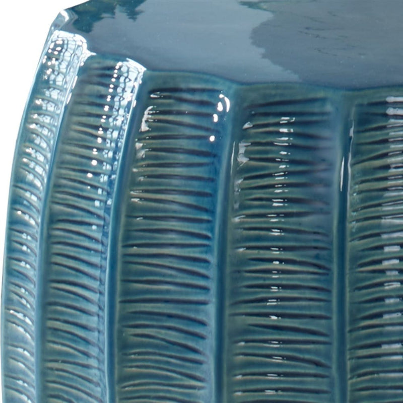 Close-up of a blue ceramic vase with textured surface