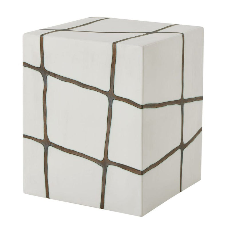 White cube-shaped ottoman with brown geometric patterns on a white background