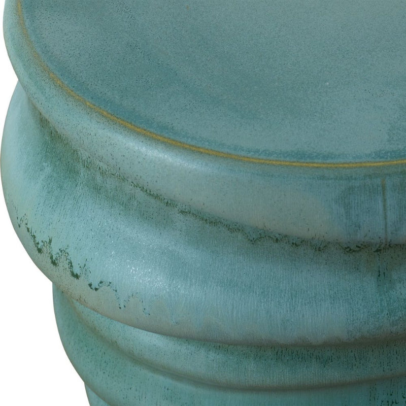Close-up of a textured teal ceramic planter with a gold rim.