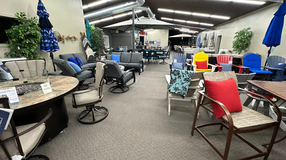 Various patio furniture collections on a showroom floor